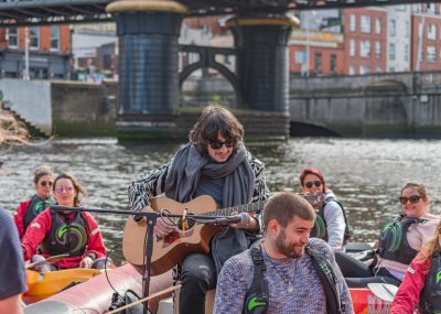 City Kayaking Music under the bridge man playing guitar on water